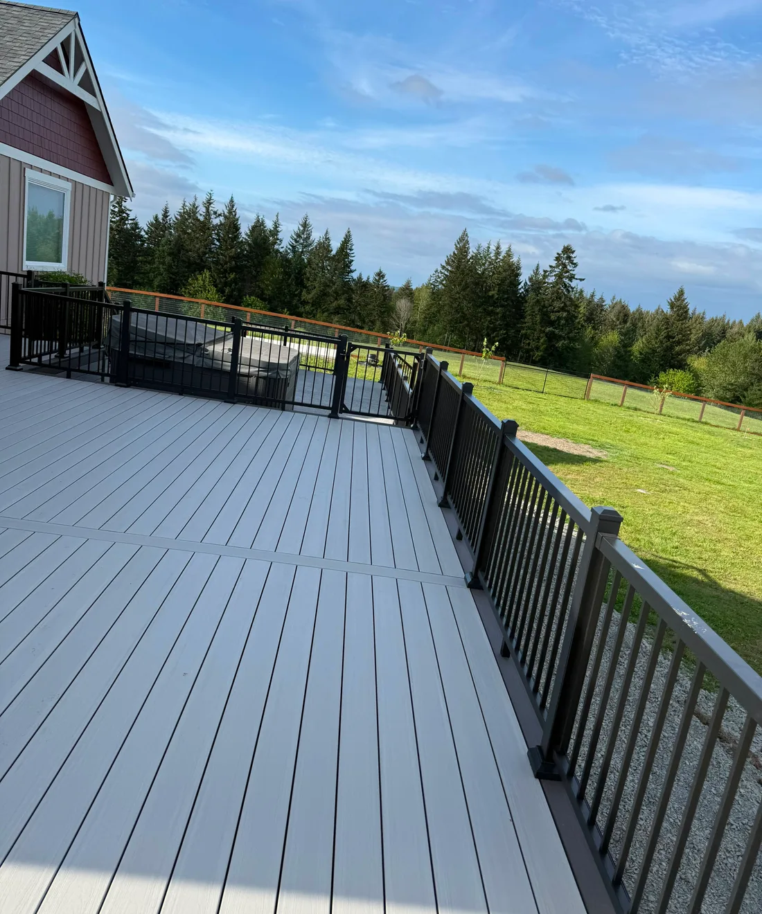 Long gray composite deck with black railing built by our crew near Seattle