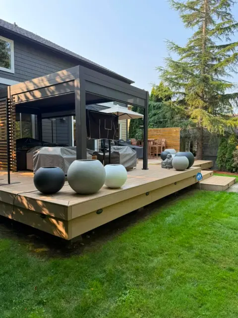 Backyard patio deck with pergola, planters and outdoor furniture