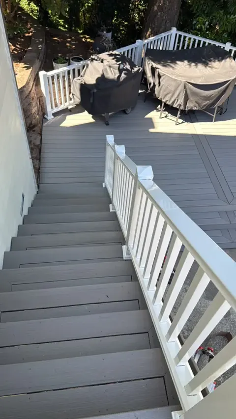 Composite deck stairs with gray boards and white railing