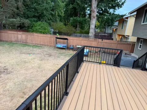Large backyard deck with black aluminum railing