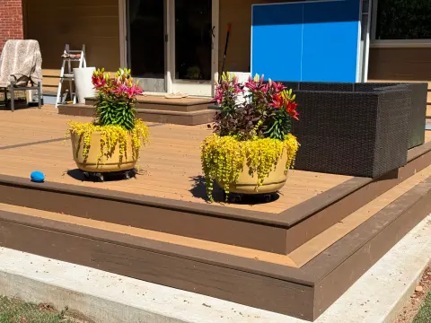 Finished brown composite deck decorated with flower pots