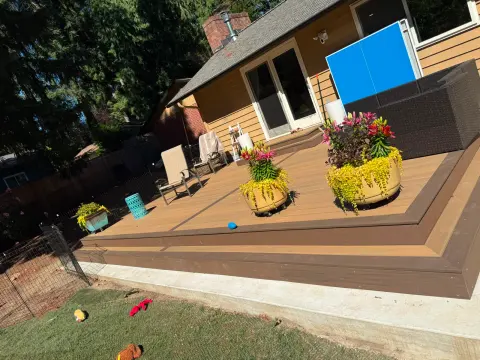 Wide brown composite deck along the back of the house