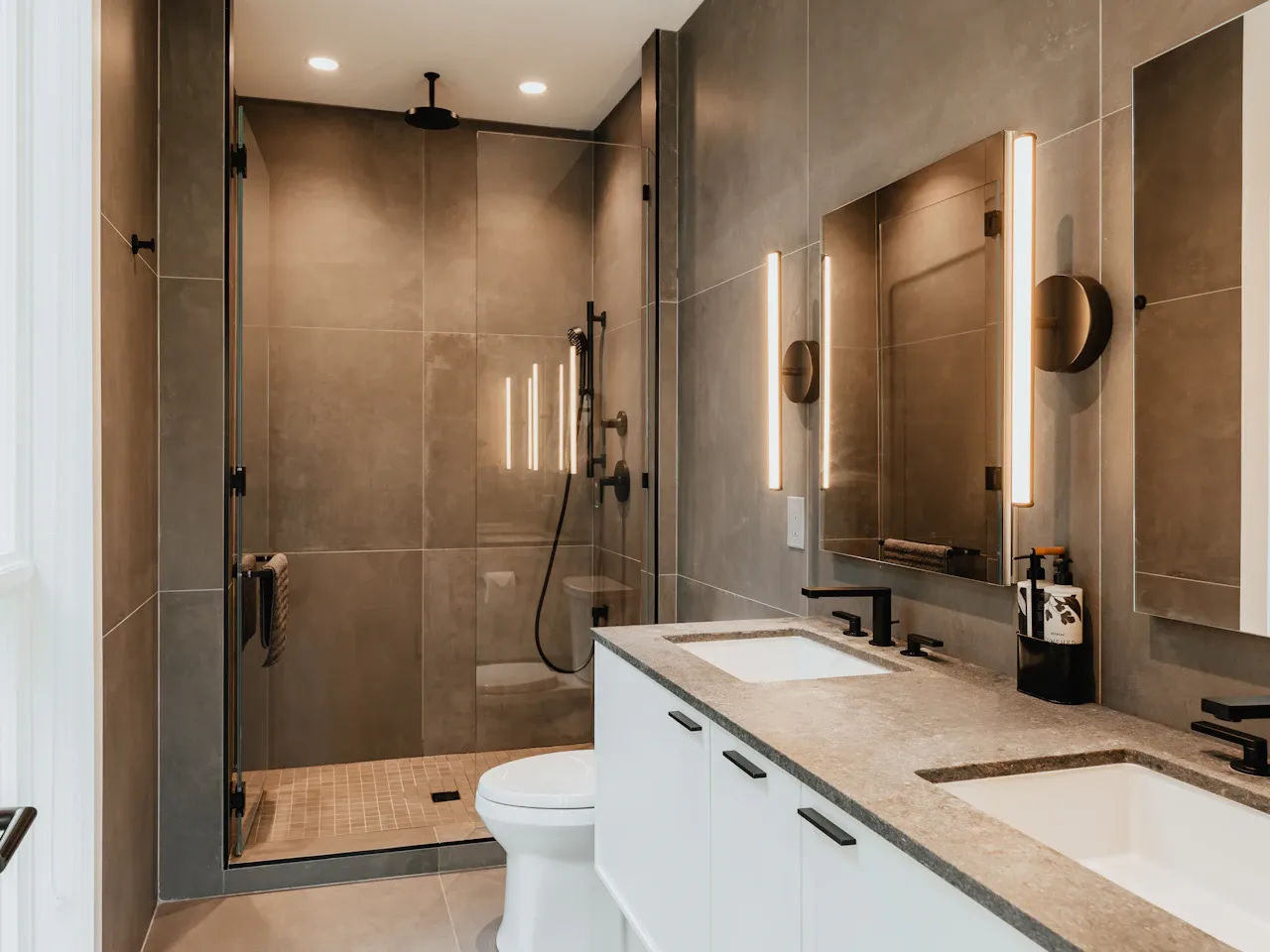 Modern remodeled bathroom with walk-in shower and double vanity
